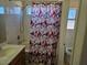 This full bathroom features a shower-tub combo and a patterned shower curtain at 7849 Blue Brook Dr, Las Vegas, NV 89147
