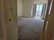 A spacious carpeted bedroom with a window and curtains for lots of natural light at 7849 Blue Brook Dr, Las Vegas, NV 89147