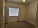 This bedroom features a ceiling fan, a window, and neutral carpet at 7849 Blue Brook Dr, Las Vegas, NV 89147