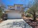 Charming two-story home with a tile roof, two car garage, and some landscaping in front at 7849 Blue Brook Dr, Las Vegas, NV 89147