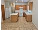 Traditional kitchen featuring wood cabinets, a white refrigerator, and a center island at 7849 Blue Brook Dr, Las Vegas, NV 89147