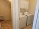 Convenient laundry area with washer and dryer hookups and overhead cabinets at 7849 Blue Brook Dr, Las Vegas, NV 89147