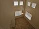 Sunlit living room boasts soaring ceilings, multiple windows, and tile floors at 7849 Blue Brook Dr, Las Vegas, NV 89147