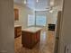 Spacious living area with fireplace, tile flooring, and adjacent kitchen island at 7849 Blue Brook Dr, Las Vegas, NV 89147
