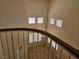 The view from the 2nd floor shows the spacious living room with many windows and neutral colors at 7849 Blue Brook Dr, Las Vegas, NV 89147