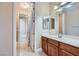 Open bathroom showcasing vanity and an open hallway at 8078 Leather Harness St, Las Vegas, NV 89131