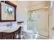 Bathroom with vanity, toilet, dark wood accents, and glass-enclosed shower at 8078 Leather Harness St, Las Vegas, NV 89131