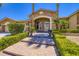 Elegant front entrance with landscaped pathway and grand arched entryway for welcoming guests at 8078 Leather Harness St, Las Vegas, NV 89131