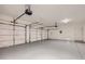 Spacious garage with smooth painted floors and a pair of insulated doors at 8078 Leather Harness St, Las Vegas, NV 89131