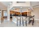 Spacious kitchen features granite counters, stainless appliances, wood cabinets and a breakfast bar with seating at 8078 Leather Harness St, Las Vegas, NV 89131