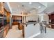 Open kitchen featuring granite counters, stainless appliances, wood cabinets, and an island breakfast bar at 8078 Leather Harness St, Las Vegas, NV 89131