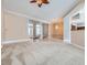 Expansive living room features neutral colors, plush carpeting, and elegant lighting fixtures at 8078 Leather Harness St, Las Vegas, NV 89131