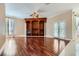 Large living room features hardwood floors, built-in shelving, and double doors leading to the backyard at 8078 Leather Harness St, Las Vegas, NV 89131