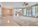Spacious room featuring a chandelier, tile and carpet flooring, neutral colors, and natural light at 8078 Leather Harness St, Las Vegas, NV 89131