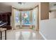 Open living room with large picture windows offering views of the outdoor pool and backyard at 8078 Leather Harness St, Las Vegas, NV 89131