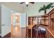 Bright office space with hardwood flooring, built-in shelving, and an open doorway to the living room at 8078 Leather Harness St, Las Vegas, NV 89131