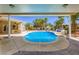 Stunning pool area with a slide, covered patio, and meticulously designed landscaping, creating a luxurious oasis at 8078 Leather Harness St, Las Vegas, NV 89131