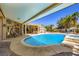 Inviting backyard featuring a shimmering pool with a slide and covered patio, perfect for outdoor entertaining at 8078 Leather Harness St, Las Vegas, NV 89131