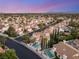 Scenic aerial view of a residential neighborhood showcasing well-maintained homes and landscaping at 8100 Lake Hills Dr, Las Vegas, NV 89128