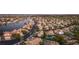 Stunning aerial view of a community with a lake, lush landscaping, and well-maintained homes at 8100 Lake Hills Dr, Las Vegas, NV 89128