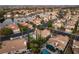 Picturesque aerial view of a lakeside community with lush landscaping, pools, and stunning architecture at 8100 Lake Hills Dr, Las Vegas, NV 89128