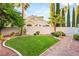 This backyard features a well-maintained lawn and tasteful landscaping at 8100 Lake Hills Dr, Las Vegas, NV 89128