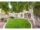 Beautiful backyard featuring a well-kept lawn, mature trees, and manicured garden beds at 8100 Lake Hills Dr, Las Vegas, NV 89128