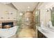 Modern bathroom featuring a walk-in shower, soaking tub, and sleek vanity at 8100 Lake Hills Dr, Las Vegas, NV 89128
