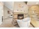 Relax in this bathroom featuring a soaking tub, fireplace, and a glass-enclosed shower at 8100 Lake Hills Dr, Las Vegas, NV 89128