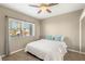 This bedroom features soft neutral walls, a ceiling fan, and a window for natural light at 8100 Lake Hills Dr, Las Vegas, NV 89128
