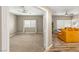 Spacious living room with tile floors and an adjacent carpeted living area at 8100 Lake Hills Dr, Las Vegas, NV 89128