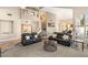 Inviting living room featuring plush black sofas and neutral decor at 8100 Lake Hills Dr, Las Vegas, NV 89128
