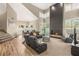 Inviting living room featuring a fireplace, vaulted ceilings, plush seating, and ample natural light at 8100 Lake Hills Dr, Las Vegas, NV 89128
