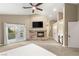 Spacious main bedroom featuring a fireplace, ceiling fan, access to a balcony, and an ensuite bathroom at 8100 Lake Hills Dr, Las Vegas, NV 89128