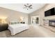 Serene main bedroom featuring a fireplace, ceiling fan, a private balcony, and a neutral color palette at 8100 Lake Hills Dr, Las Vegas, NV 89128