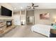 Spacious main bedroom featuring a fireplace, TV, ceiling fan, carpet flooring, and a king bed at 8100 Lake Hills Dr, Las Vegas, NV 89128