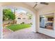 Covered patio with brick flooring and a view of the well maintained backyard at 8100 Lake Hills Dr, Las Vegas, NV 89128
