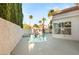 Sparkling pool and spa with a view of the home's exterior and mature trees at 8100 Lake Hills Dr, Las Vegas, NV 89128