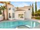 Enjoy this home's private swimming pool and hot tub surrounded by beautiful landscaping at 8100 Lake Hills Dr, Las Vegas, NV 89128