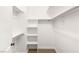 Walk-in closet with built-in shelves and metal rods for hanging clothes with carpet flooring at 8100 Lake Hills Dr, Las Vegas, NV 89128