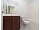 Bathroom with dark wood vanity, toilet, and a shower-tub combo at 835 Jigglypuff Pl, Henderson, NV 89011