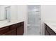 Bright bathroom features double sinks and a glass enclosed shower at 835 Jigglypuff Pl, Henderson, NV 89011