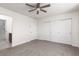 Spacious bedroom featuring a ceiling fan, carpet flooring, and a large closet with sliding doors at 835 Jigglypuff Pl, Henderson, NV 89011