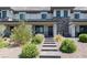 Charming townhome with stone accents, landscaped front yard, and inviting entryway at 835 Jigglypuff Pl, Henderson, NV 89011