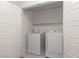 Laundry area featuring a white washer and dryer unit with shelving above at 835 Jigglypuff Pl, Henderson, NV 89011