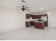 Spacious open living room with tiled floors leads to a modern kitchen at 835 Jigglypuff Pl, Henderson, NV 89011