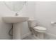 Bright powder room features a pedestal sink, toilet, and neutral paint at 835 Jigglypuff Pl, Henderson, NV 89011