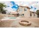 Expansive backyard with refreshing pool, spa, and a cozy fire pit, perfect for outdoor gatherings at 8401 Airmont Ct, Las Vegas, NV 89128