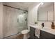Bathroom with sliding glass shower, modern vanity, and neutral color scheme at 8401 Airmont Ct, Las Vegas, NV 89128