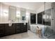 Modern bathroom features a soaking tub, glass shower, double vanity and sleek fixtures at 8401 Airmont Ct, Las Vegas, NV 89128